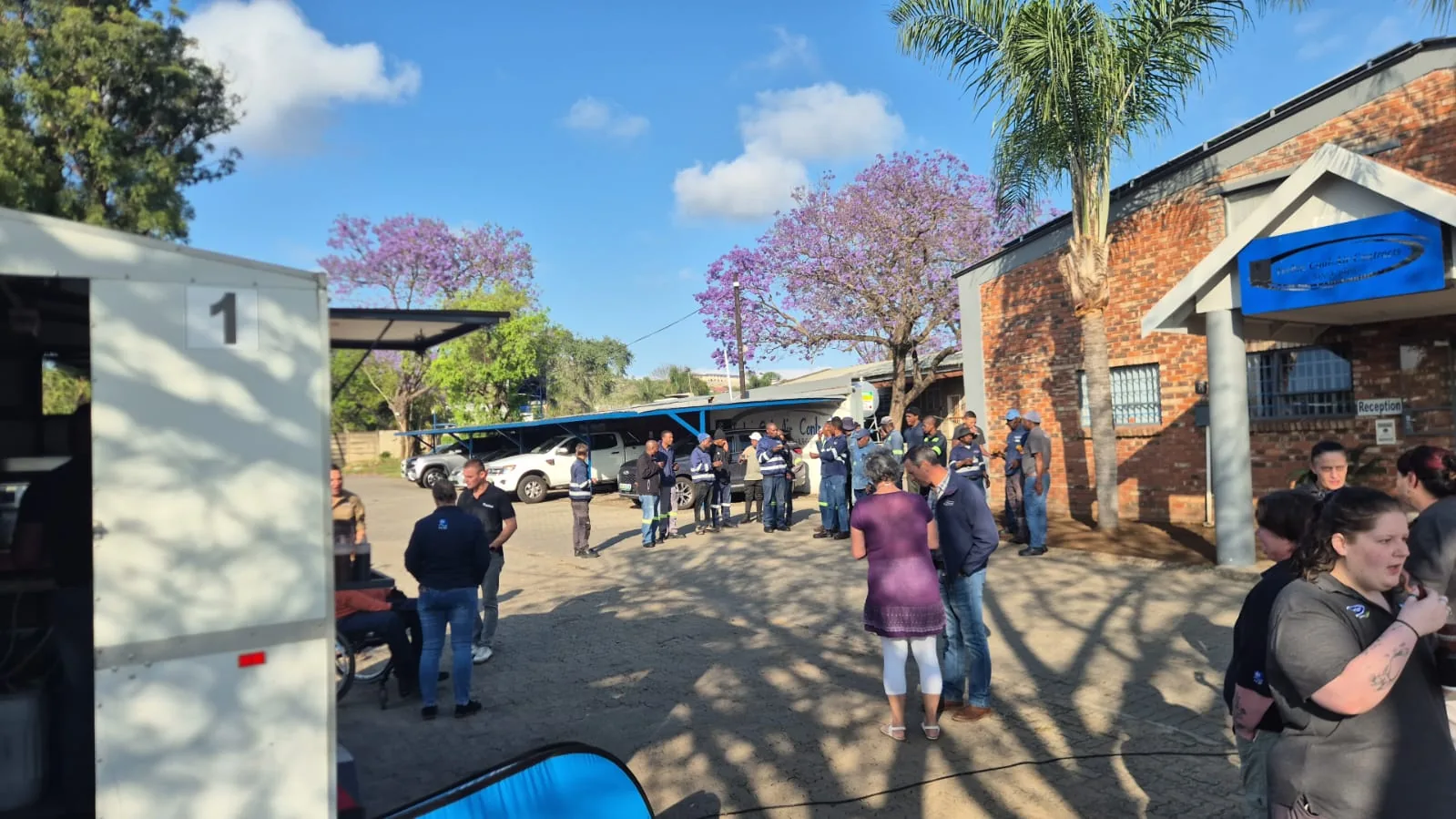 Guests walking between outdoor event stalls